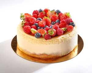 Cheesecake garnished with berries on a white background