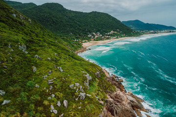 Tropical coastline with mountains and ocean with waves in Brasil. Aerial view