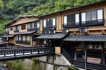 Fototapeta na wymiar Historical Onsen Ryokan facing river at Aso, Kumamoto, Japan 
