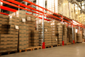 Warehouse with lots of products, blurred view. Wholesale business