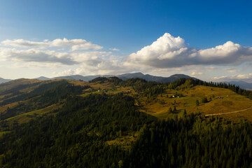 Aerial view of beautiful mountain landscape with forest on sunny day. Drone photography