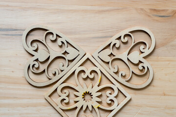 fancy laser cut wooden hearts on a wooden surface