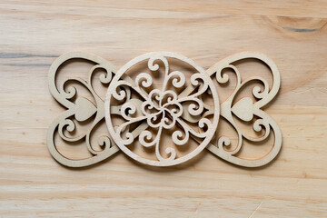 fancy laser cut wooden hearts on a wooden surface