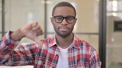 Portrait of African Man showing Thumbs Down Gesture