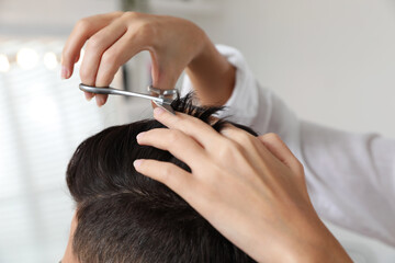 Professional stylist working with client in salon, closeup. Hairdressing services during Coronavirus quarantine