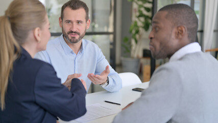 Successful Mixed Race Business People Shaking Hands after Agreement