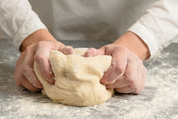 Woman hands kneading whole wheat flour bread dough