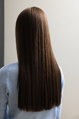 Woman with straight hair indoors, back view