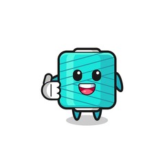yarn spool mascot doing thumbs up gesture