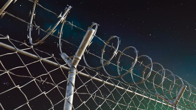 Endless view at the top of prison or airport fence on night sky background. 4kHD