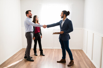 Side view of clients meeting a real estate agent