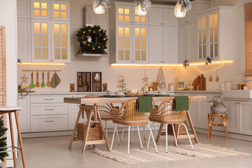 Cozy open plan kitchen decorated for Christmas. Interior design