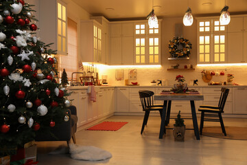 Cozy dining room interior with Christmas tree and beautiful festive decor