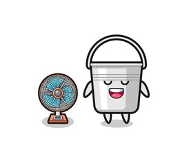 cute metal bucket is standing in front of the fan