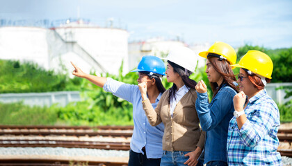 Double exposure of Engineer with safety helmet in front of Oil refinery and gas industry - refinery at sunset background, Business Insustrail concept