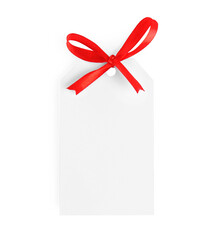 Blank gift tag with red satin ribbon on white background, top view