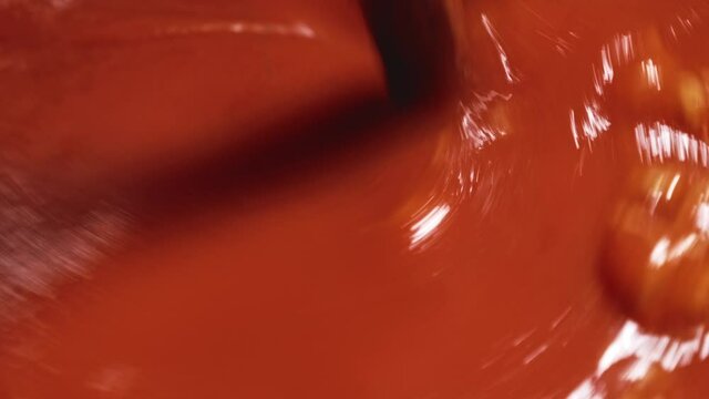 Super Close-up View of a Wooden Pot Spoon Stirring in Pasta Bolognese Sauce - Steady Shot