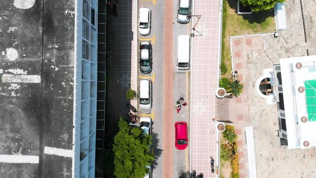 Straight Down Drone Shot Of George Town City Centre, Showing People Walking, Birds Flying And Parked Cars. Malaysia