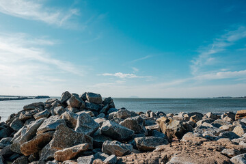 Fototapeta na wymiar Skyline Beach View with Rocks and Sea against Clear Sky.