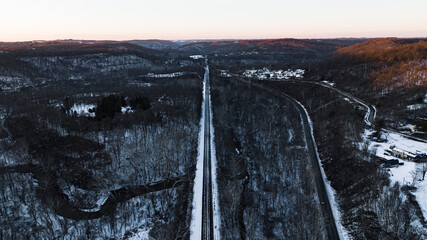 bridge in the mountains over train tracks