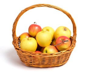 Fruits, apples and tangerines in a wicker basket on white background.
