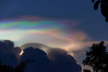 Beautiful iridescent cloud, Irisation. Skyscraper background.