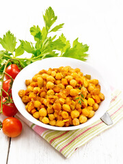 Chickpeas with vegetables stewed in plate on white board