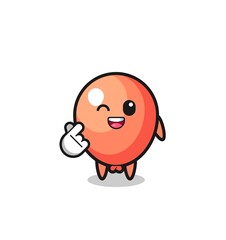 balloon character doing Korean finger heart