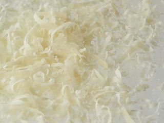 Whole and grated italian hard cheese Grana Padano or Parmesan isolated on white background....