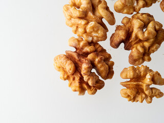 Top view of a pile of nutritious fresh walnuts without a shell isolated on a white background