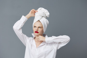 pretty woman white shirt cosmetics with towel on head isolated background