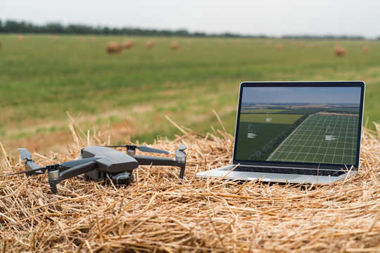 Laptop and drone on the field. Smart farming and agriculture digitalization