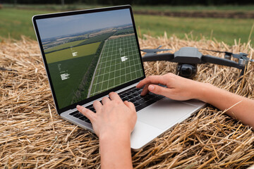 Farmer with laptop and drone on the field. Smart farming and agriculture digitalization