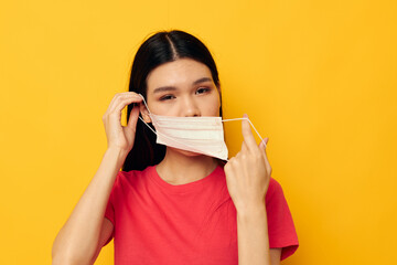 Portrait Asian beautiful young woman in red t-shirt medical mask protection Lifestyle unaltered