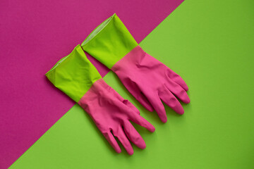 pink rubber gloves on green background