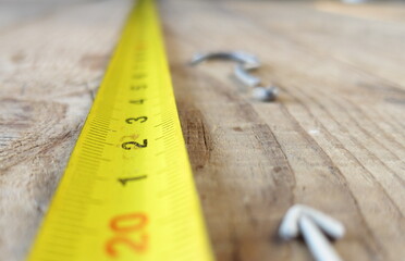 Measuring tape on wooden table