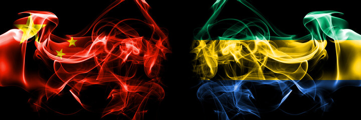 Flags of China, Chinese vs Gabon, Gabonese, Gabonian. Smoke flag placed side by side on black background.