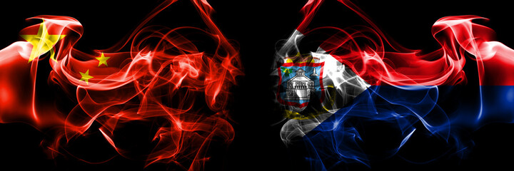 Flags of China, Chinese vs Netherlands, Dutch, Holland, Sint Maarten. Smoke flag placed side by side on black background.