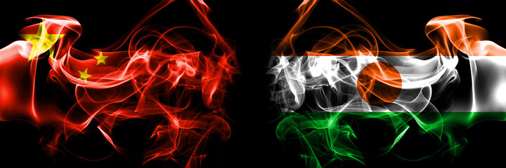 Flags of China, Chinese vs Niger, Nigerien. Smoke flag placed side by side on black background.