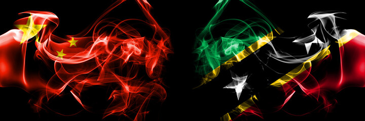 Flags of China, Chinese vs Saint Kitts and Nevis. Smoke flag placed side by side on black background.