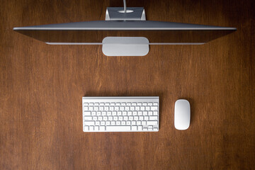 Top view, computer on a wooden table, work desk.