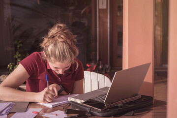 young woman or student teleworking on the terrace