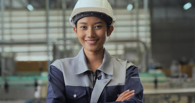 Portrait of male engineer looking to camera and smile at modern factory. Industry, Engineer and Construction concept.