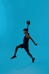 Fototapeta na wymiar Focused player jump and throw basketball ball