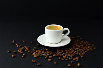 Obraz na płótnie Canvas Cup of black coffee, roasted coffee beans on table on a black background, espresso, coffee couple