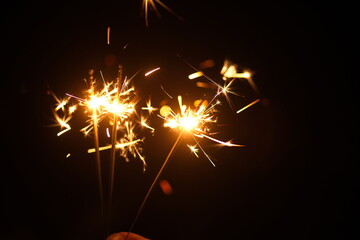 gold sparkler on black background