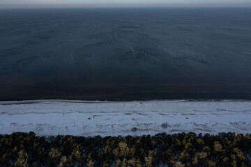 Hel peninsula and snowy beach. Baltic Sea at winter, Poland. Aerial view of winter at sea