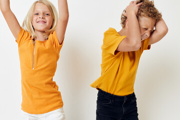 cute boy and girl in yellow t-shirts childhood entertainment studio