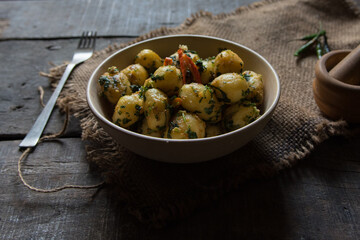 Close up of Indian food item aloo dum or fried potatoes in a bowl. - obrazy, fototapety, plakaty