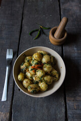 Top view of aloo dum or fried baby potatoes in a bowl.